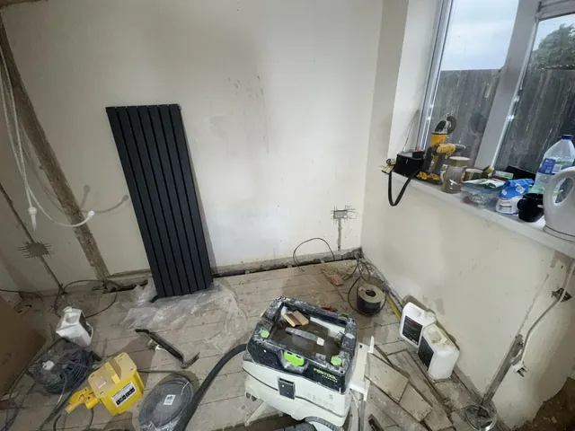 Dining area with a vertical radiator during the refurbishment