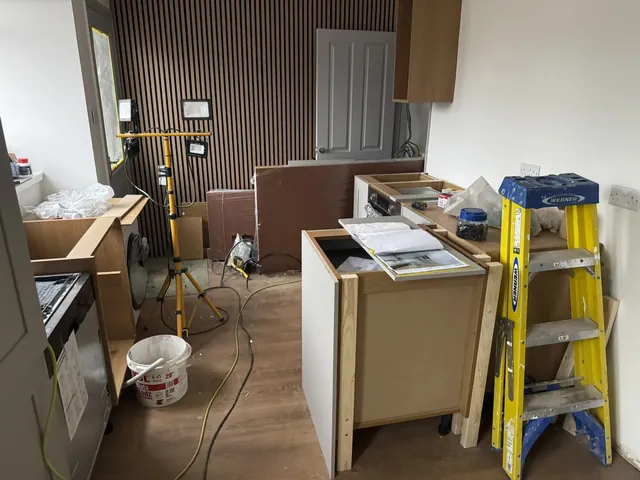 Kitchen cabinets, breakfast bar and wall panels during installation