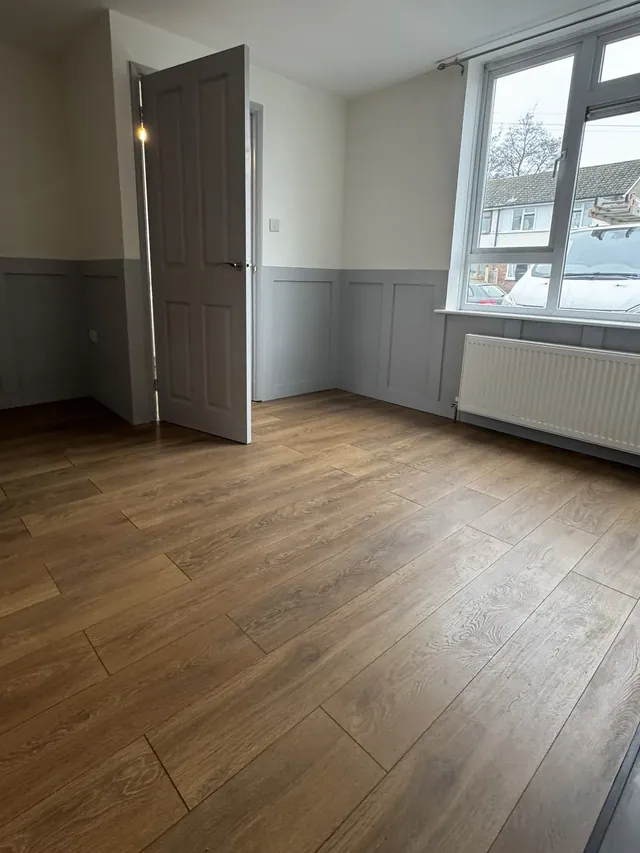 Finished living room with a coordinated floor and wall finish