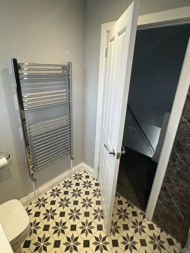 Bathroom towel rail, patterned floor and doorway details