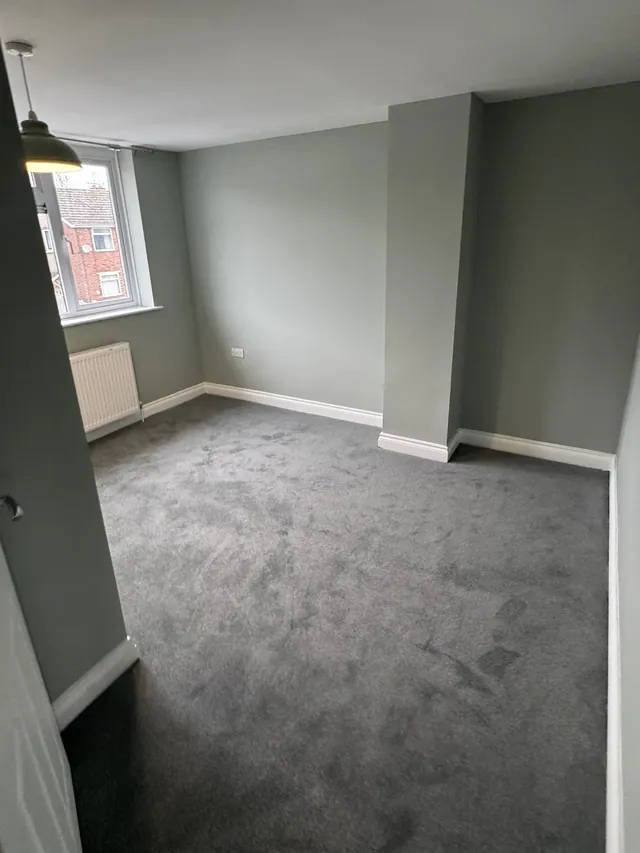 Finished bedroom with coordinated painted walls and fitted carpet