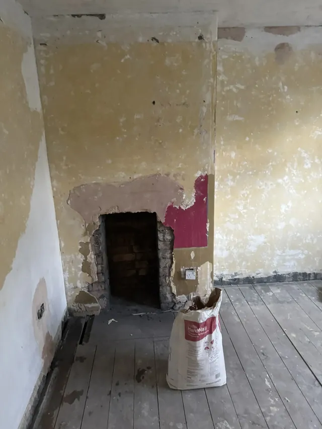 Bedroom fireplace wall before refurbishment