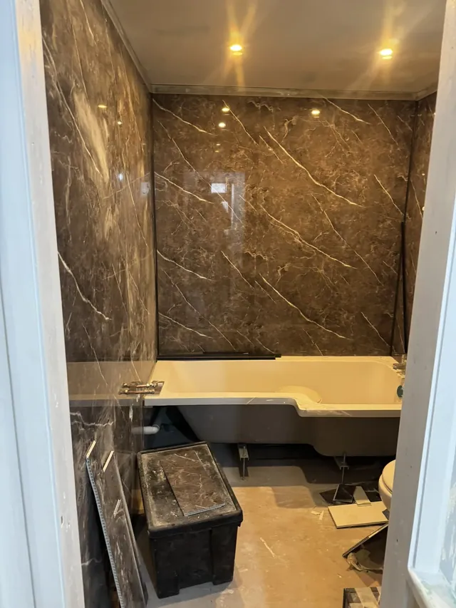 Bathroom fittings and wall panels during installation