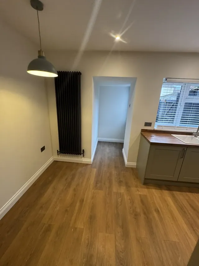 Kitchen dining area with pendant lighting and vertical radiator