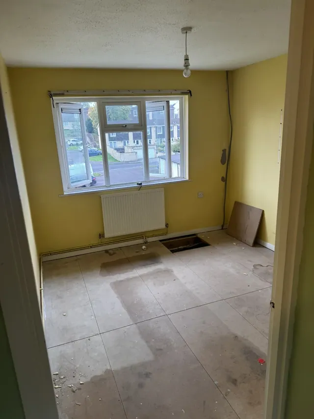 Room with yellow walls before refurbishment