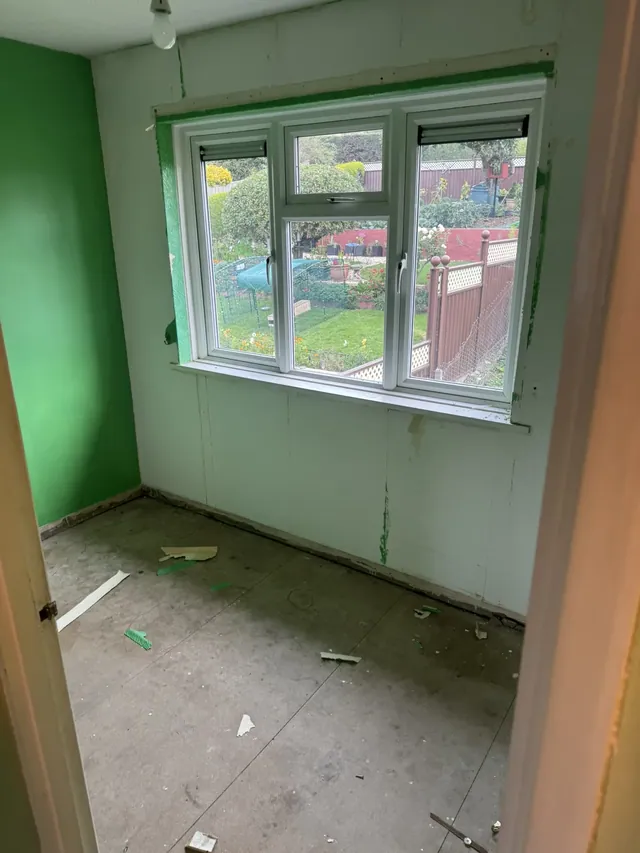 Room with green walls before refurbishment