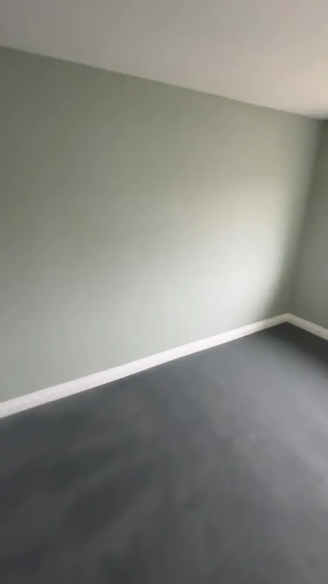 Later view of a decorated room with grey carpet