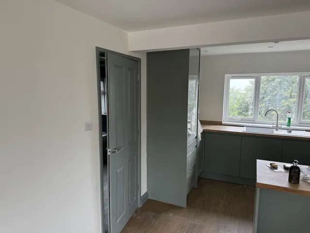 Fitted kitchen viewed from the living area during finishing