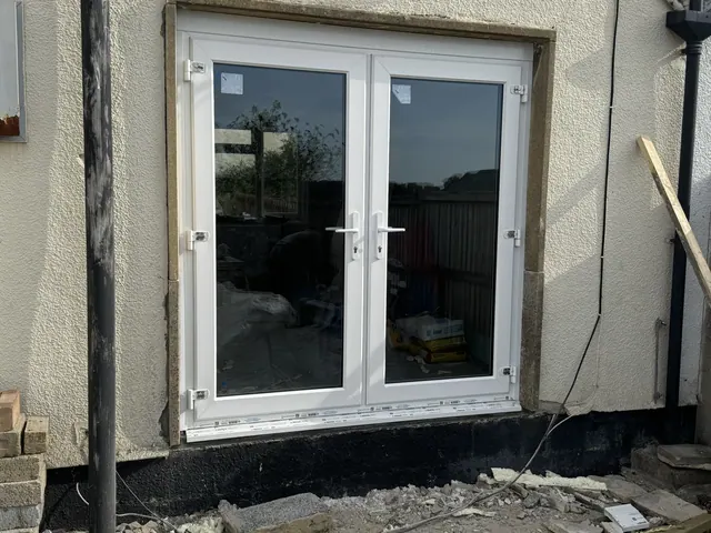New glazed rear doors during installation and making good