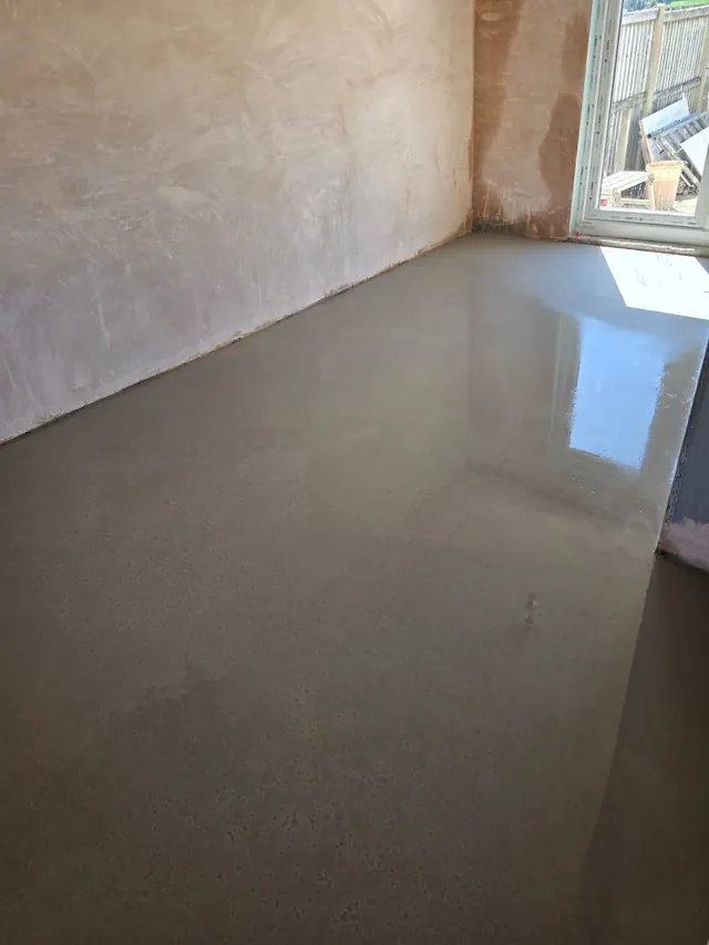 Fresh floor-levelling compound during internal preparation