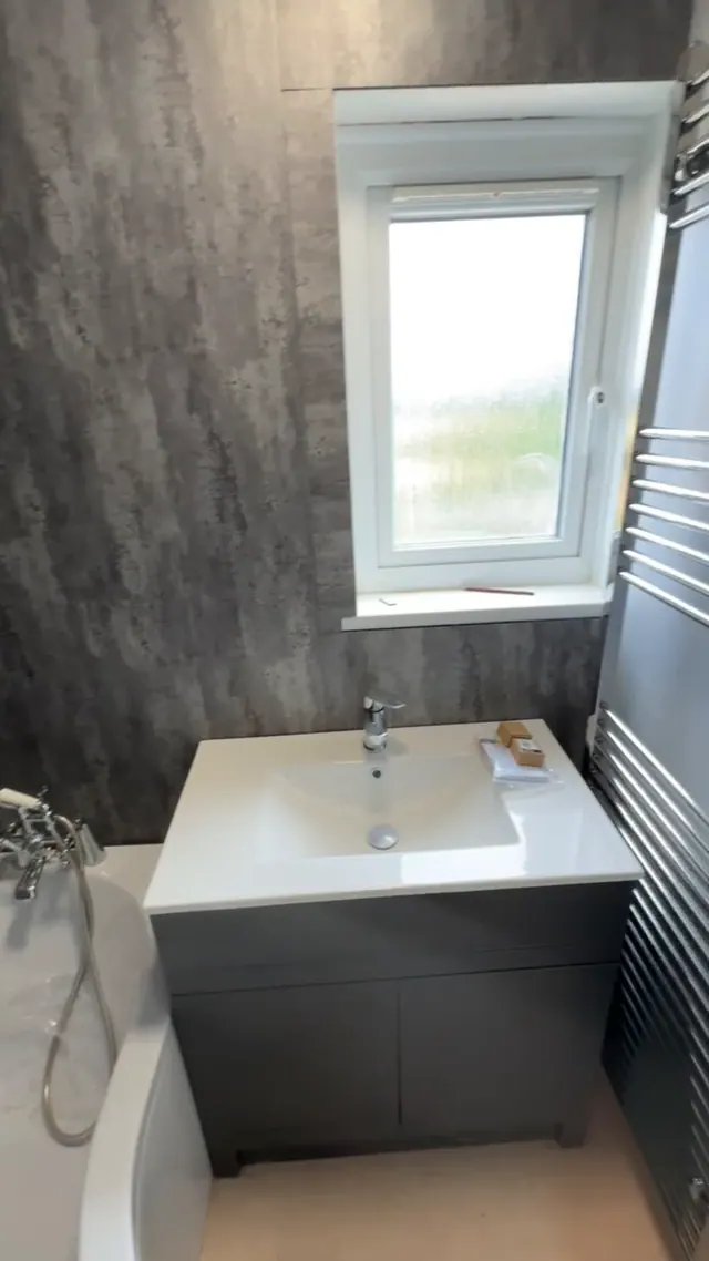 Fitted vanity unit, basin and towel rail in the updated bathroom