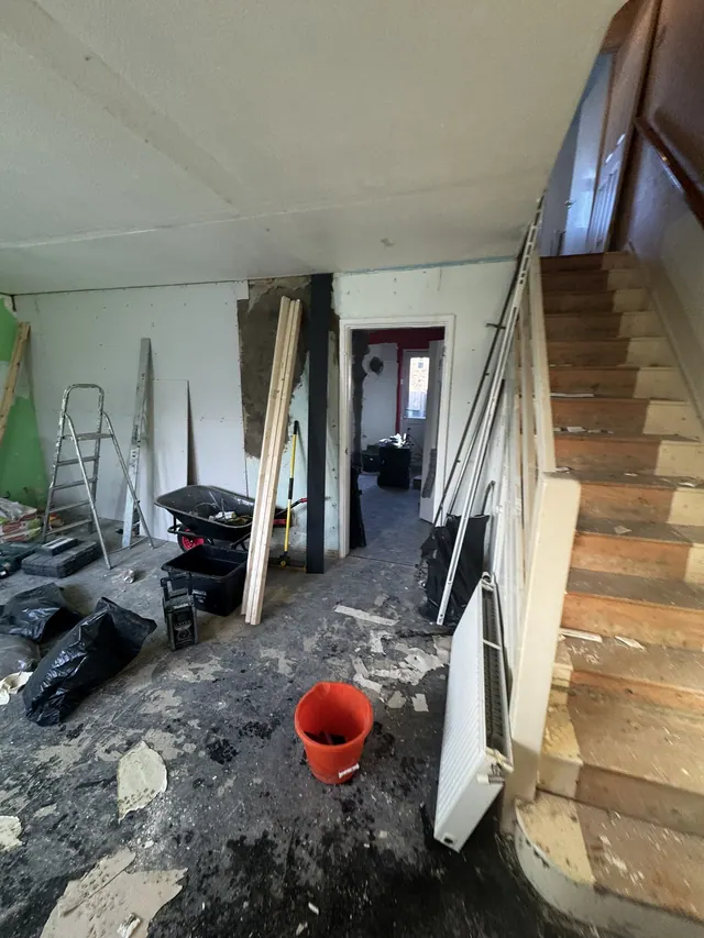 Hallway and staircase during early strip-out and preparation