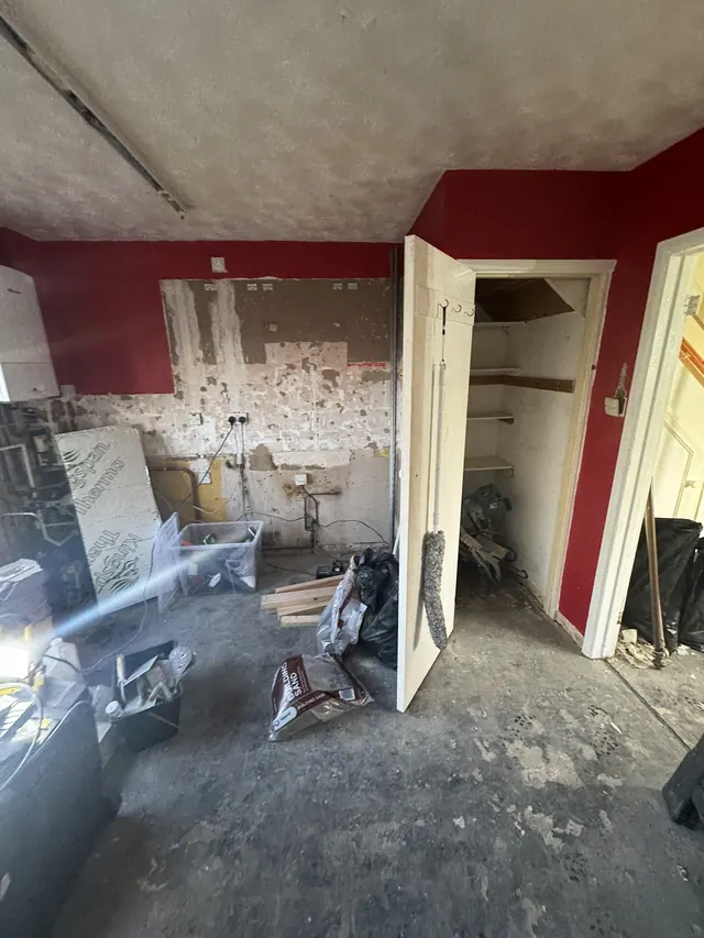 Kitchen walls and services exposed during strip-out